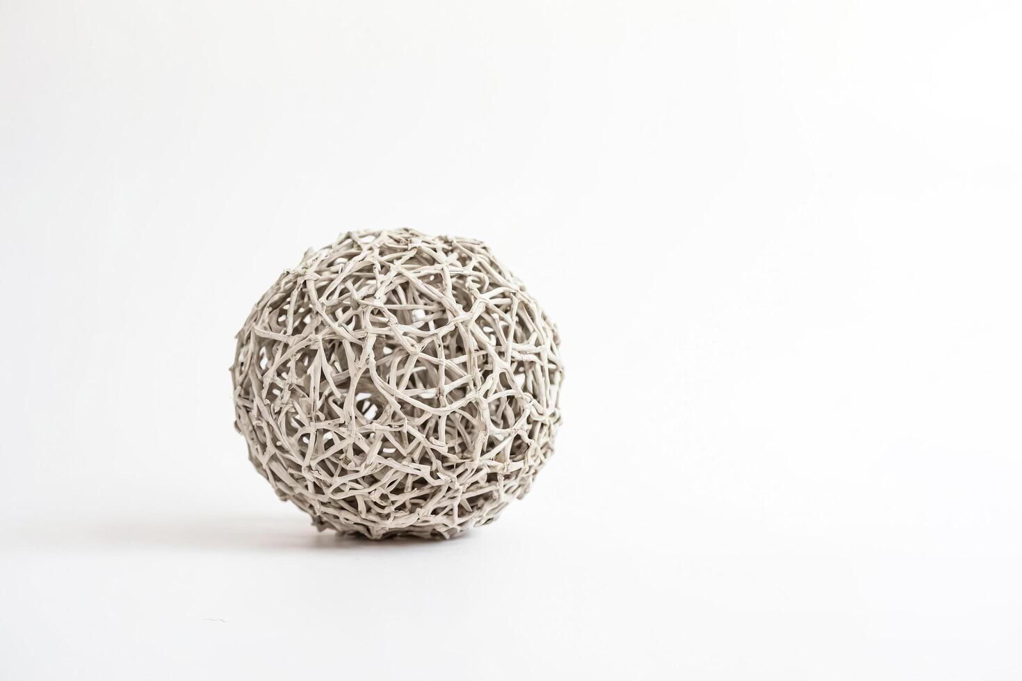 White wicker ball on white background photo