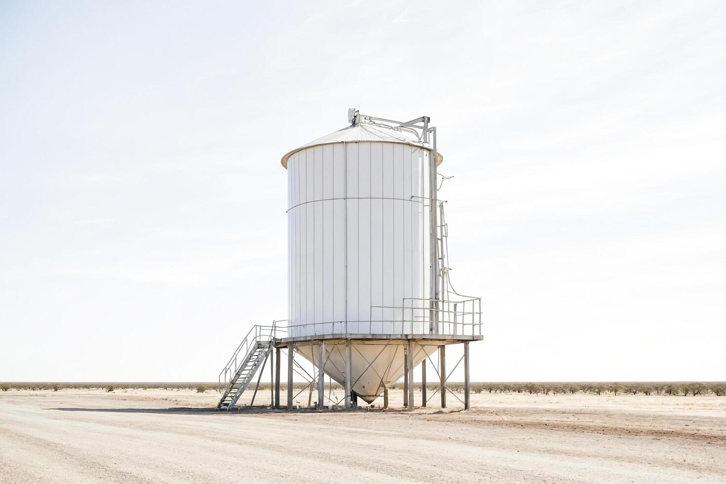 White Grain Silo in a Dry Desert Landscape photo