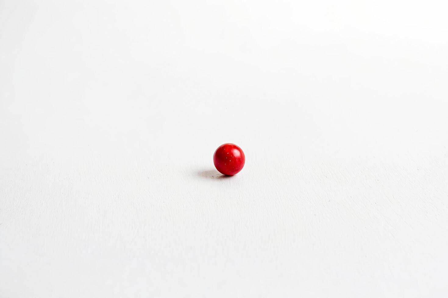 Single red ball on white background photo