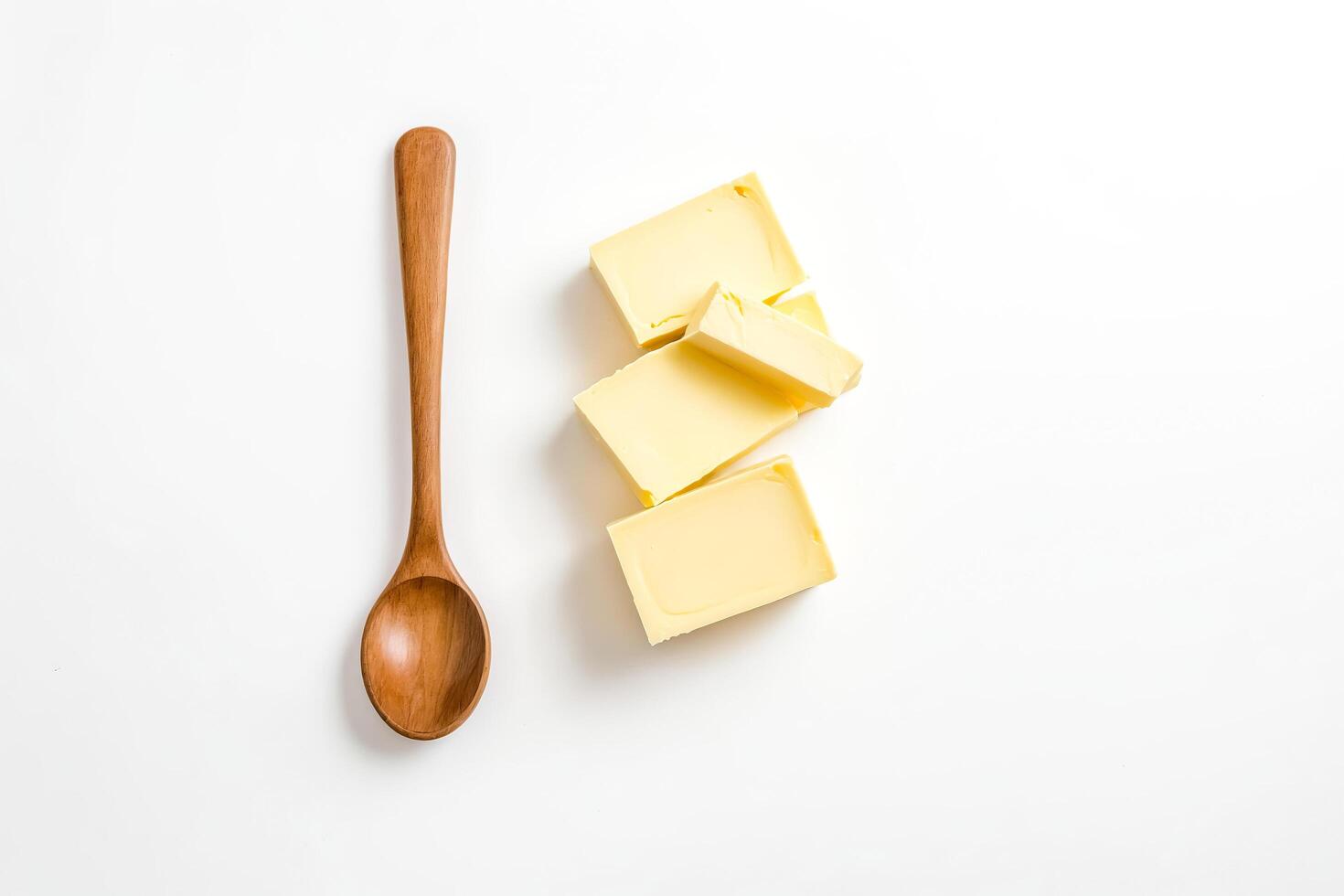 Wooden Spoon and Butter on White Background photo