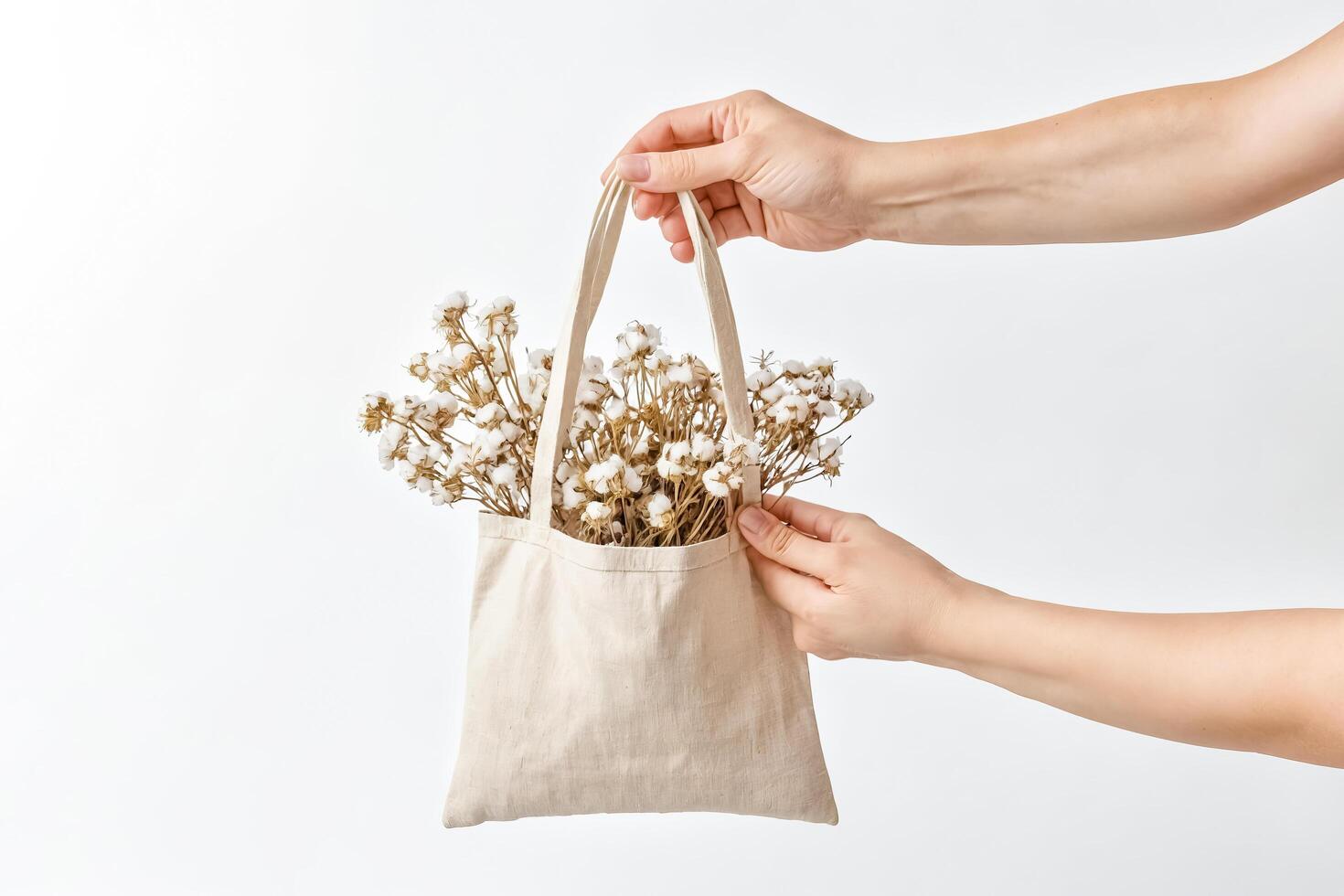 Woman holding a tote bag with cotton flowers photo