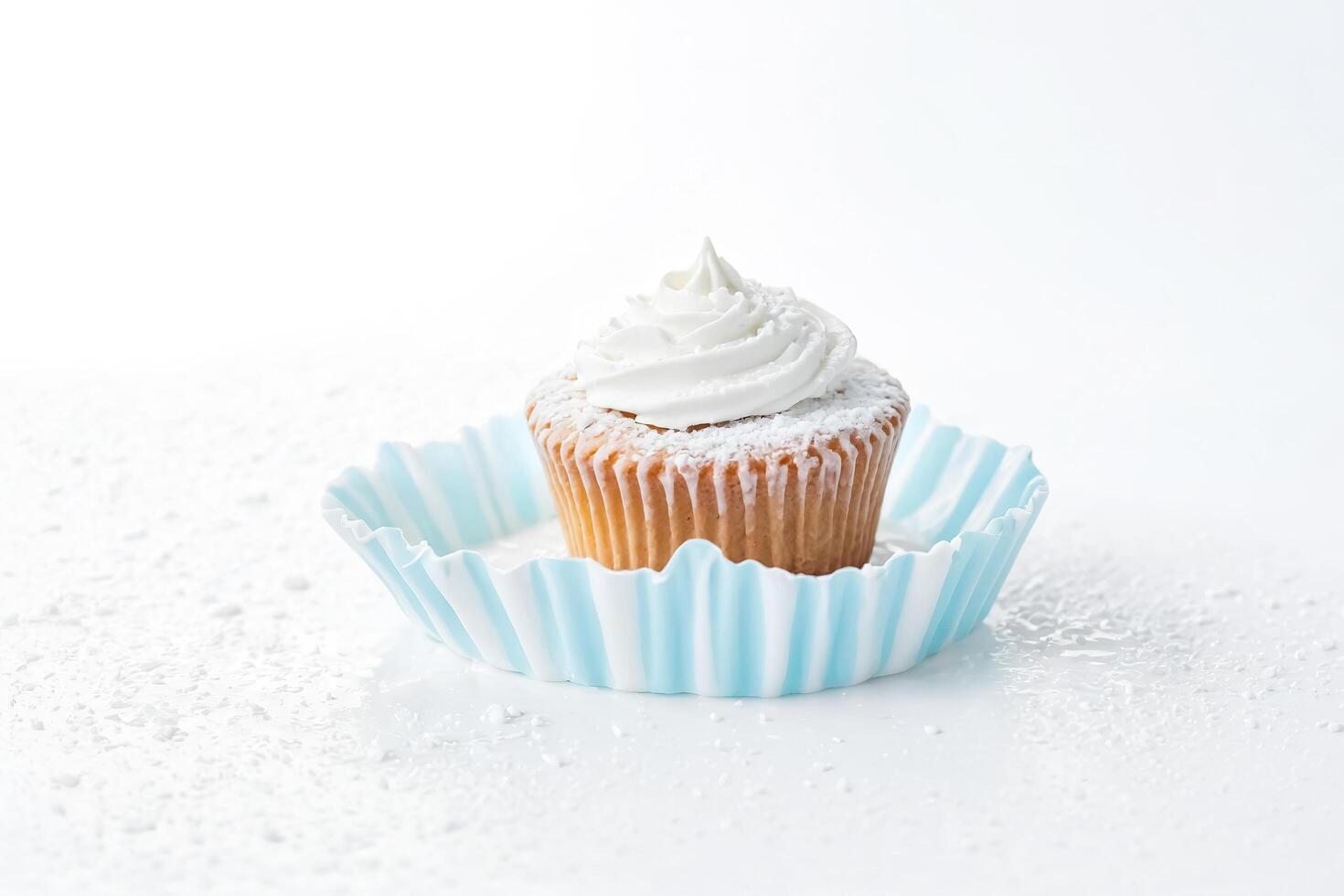 Vanilla Cupcake With Whipped Cream and Sprinkles photo