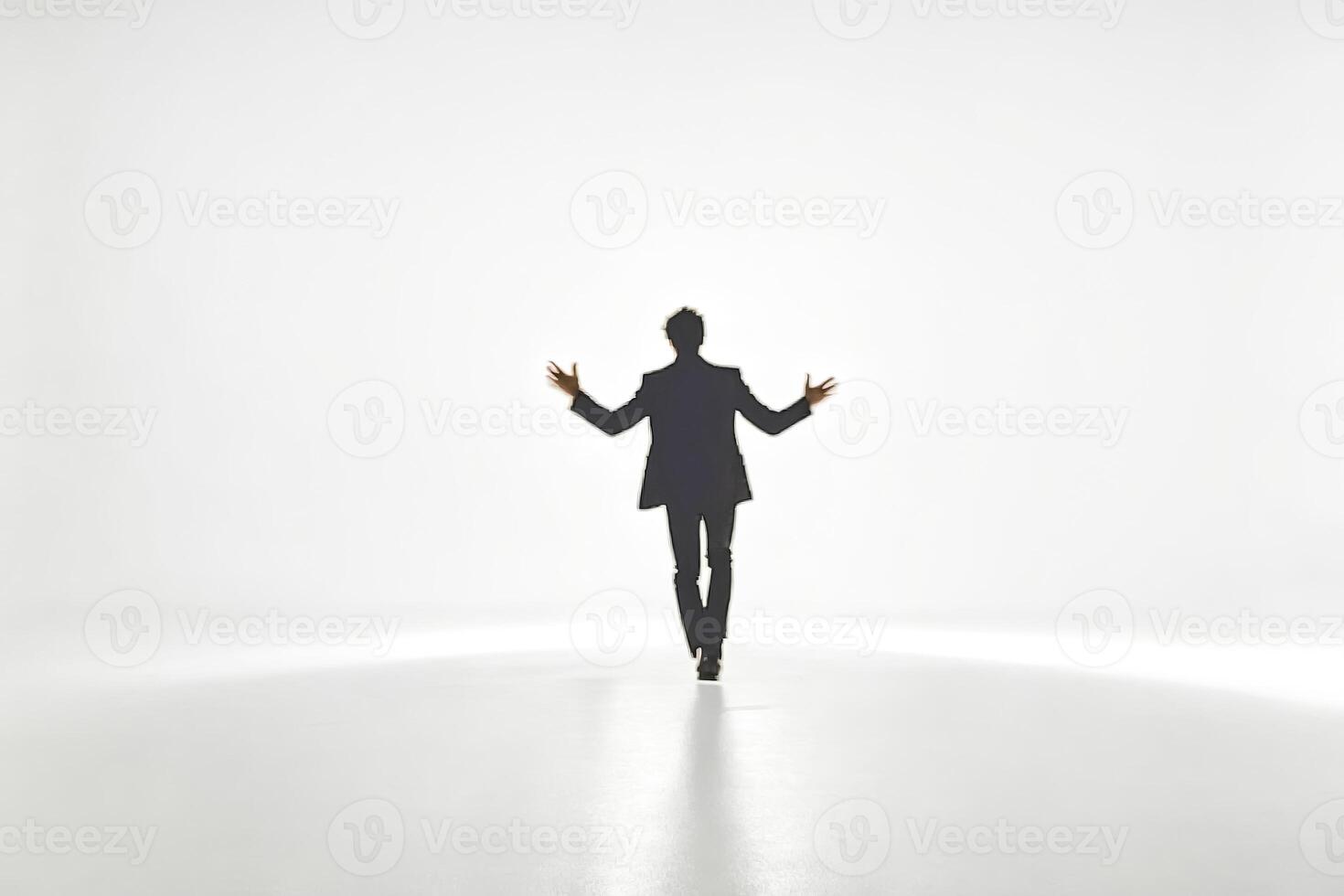 Silhouette of a man with arms out in a white studio photo