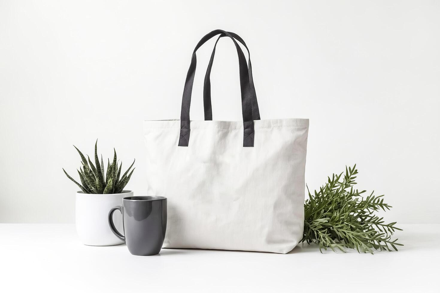White Canvas Tote Bag Mockup with Green Plants and Grey Mug photo