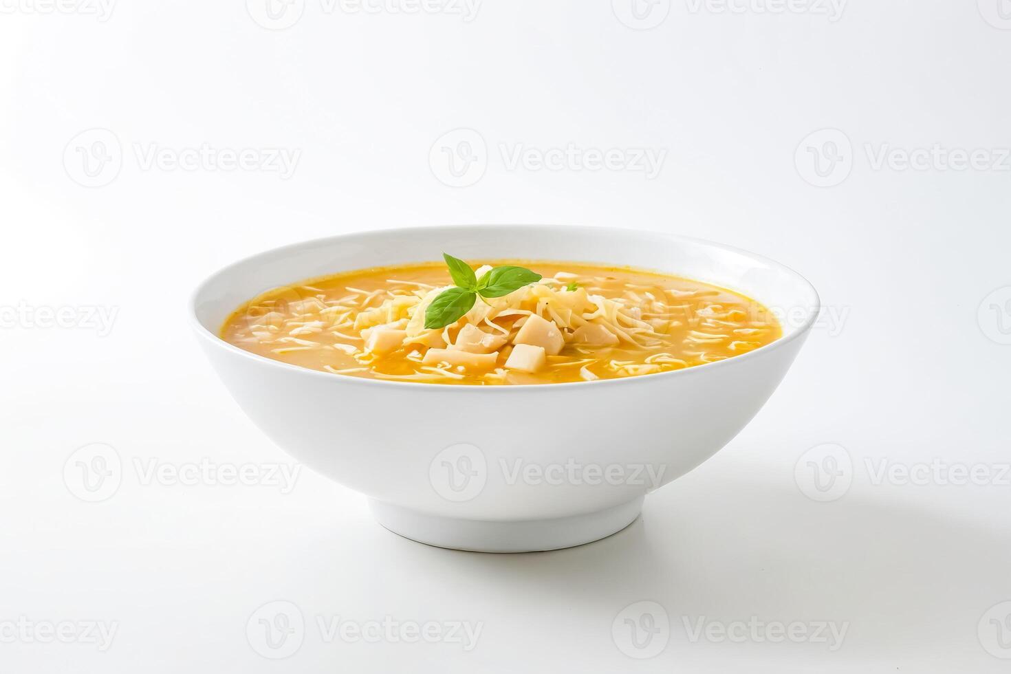 Close-up of a bowl of creamy soup with noodles, cheese, and basil photo