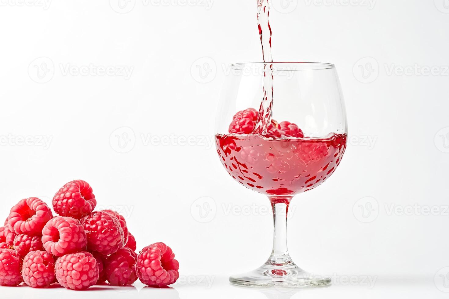 Raspberry juice pouring into a glass photo