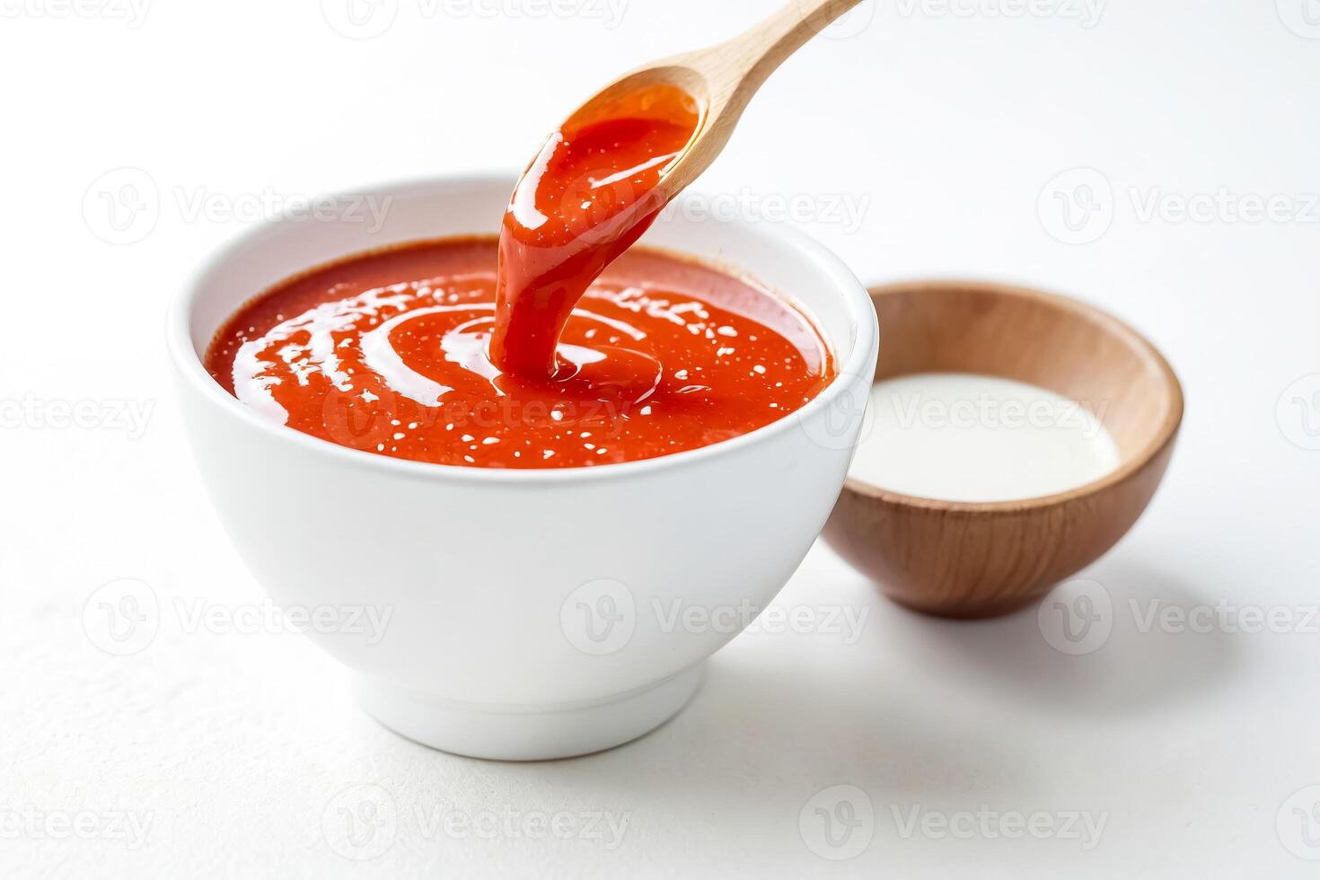 Close-up of Red Sauce Pouring Into a Bowl photo
