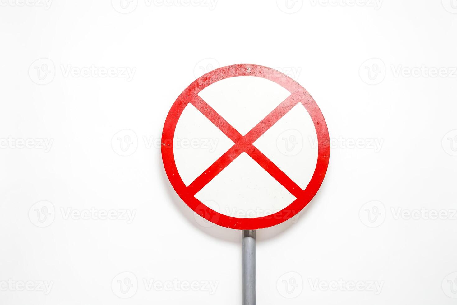 Red and white prohibition sign with a cross in the center photo