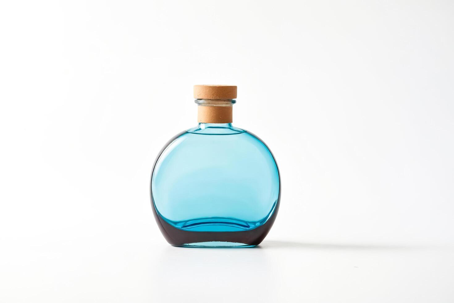 Blue Glass Bottle with Cork Stopper on White Background photo