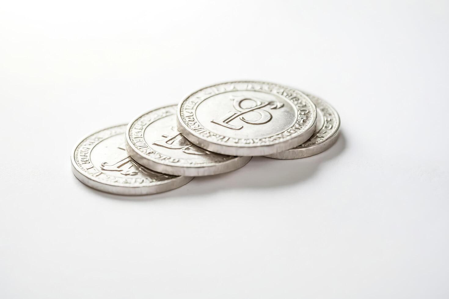 Silver Litecoin Coins Stacked on White Background photo