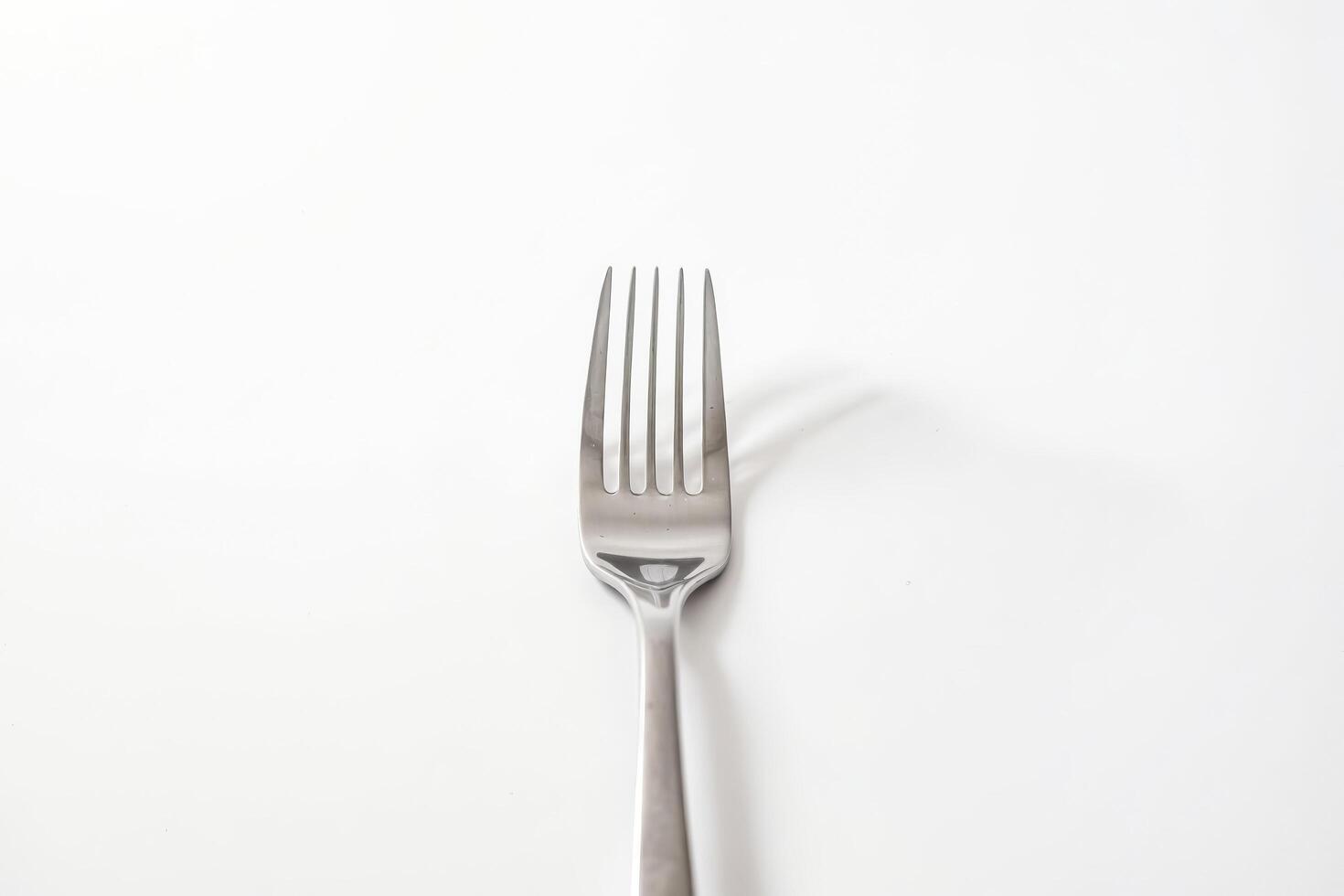 Single Silver Fork on White Background photo