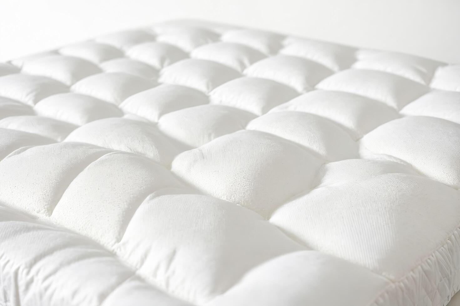 White quilted mattress topper close-up photo