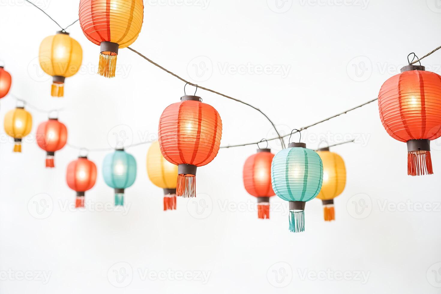Colorful Paper Lanterns Hanging on String Against White Background photo