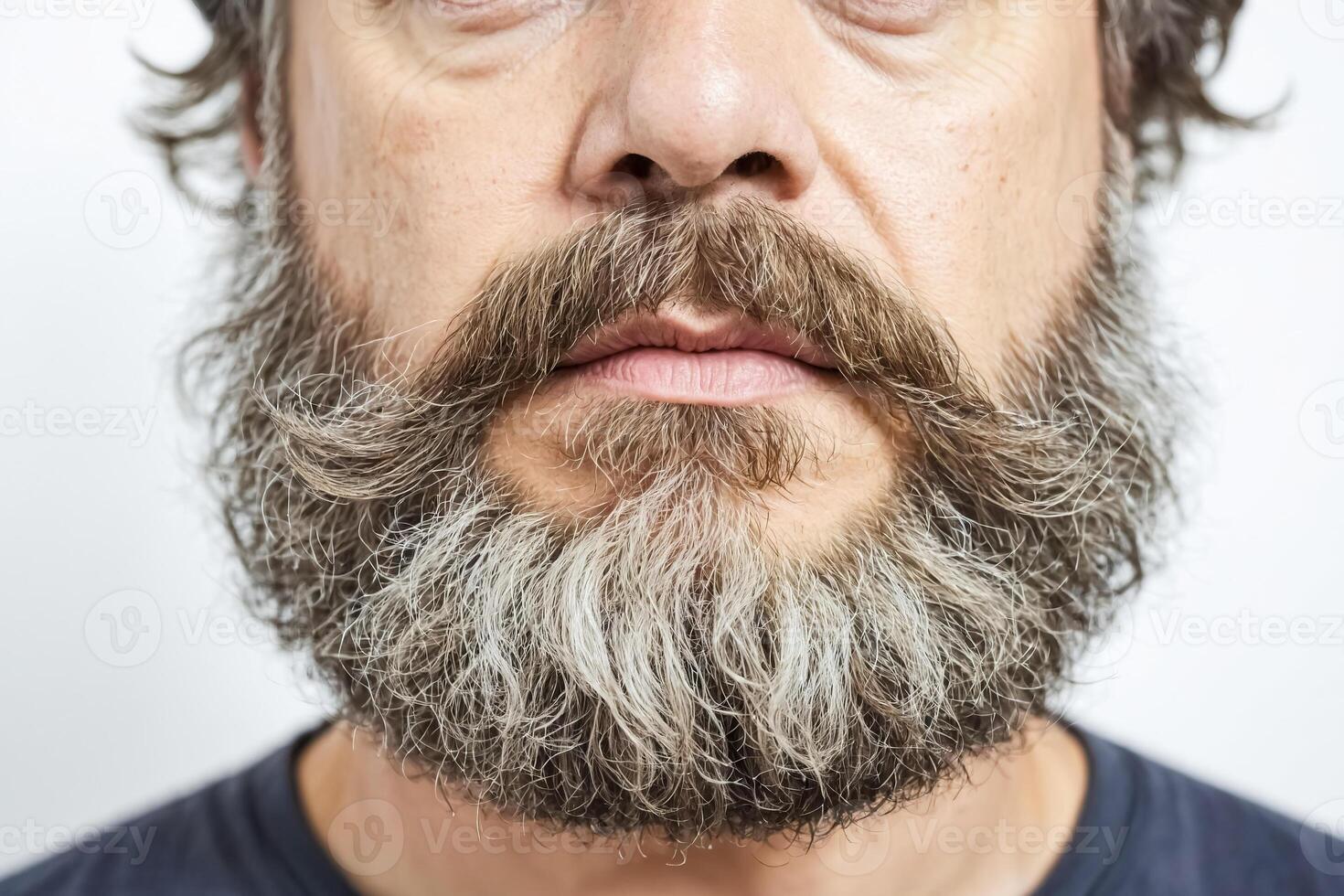 Close-up of a man's face with a full beard and mustache photo
