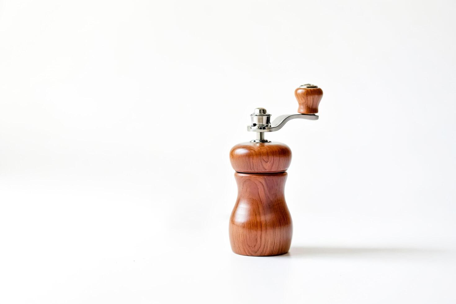 Wooden Pepper Mill with Silver Crank on White Background photo
