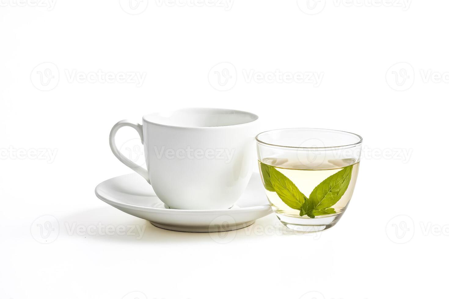A White Cup and Saucer with a Glass of Green Tea photo