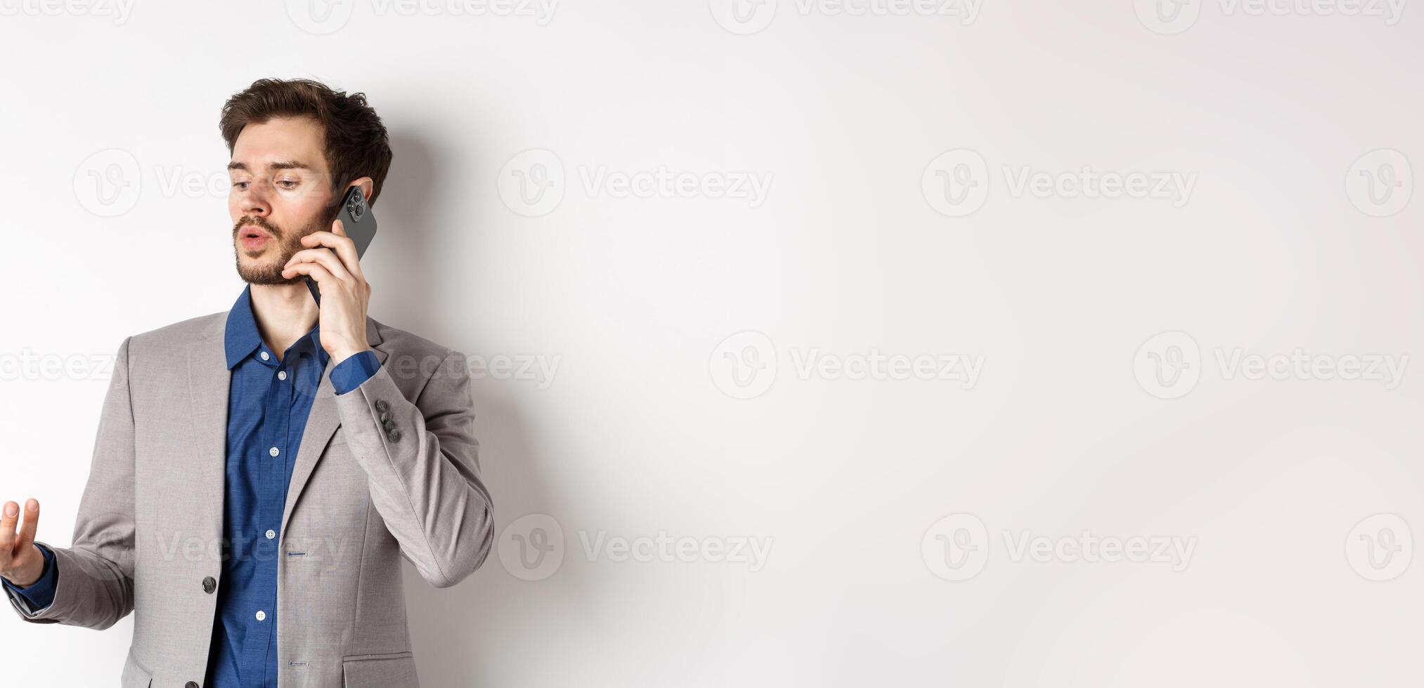 Handsome businessman having business call on phone, gesturing while talking on mobile, having conversation, white background photo