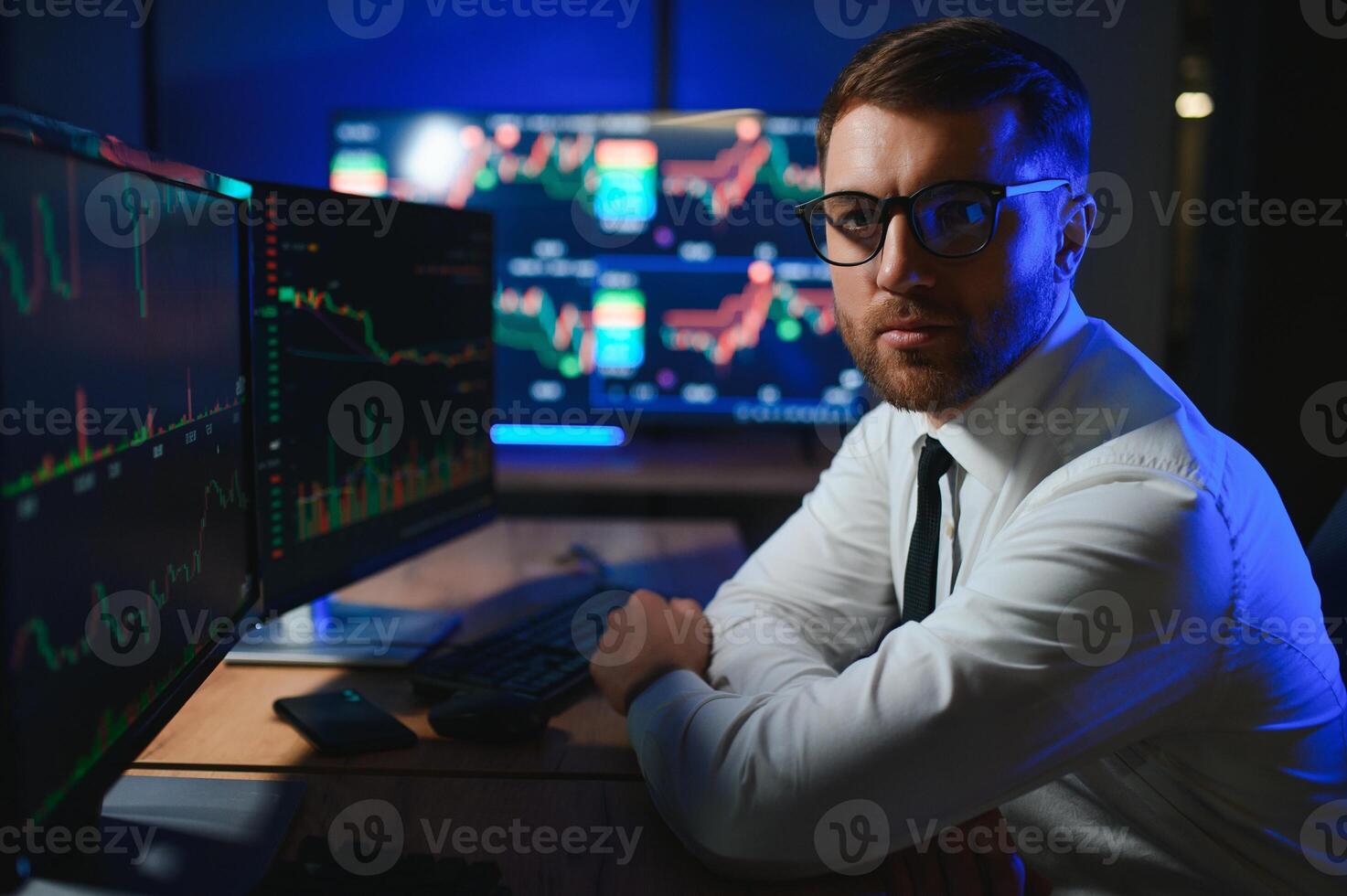 businessman comparing stock market data late in the evening photo