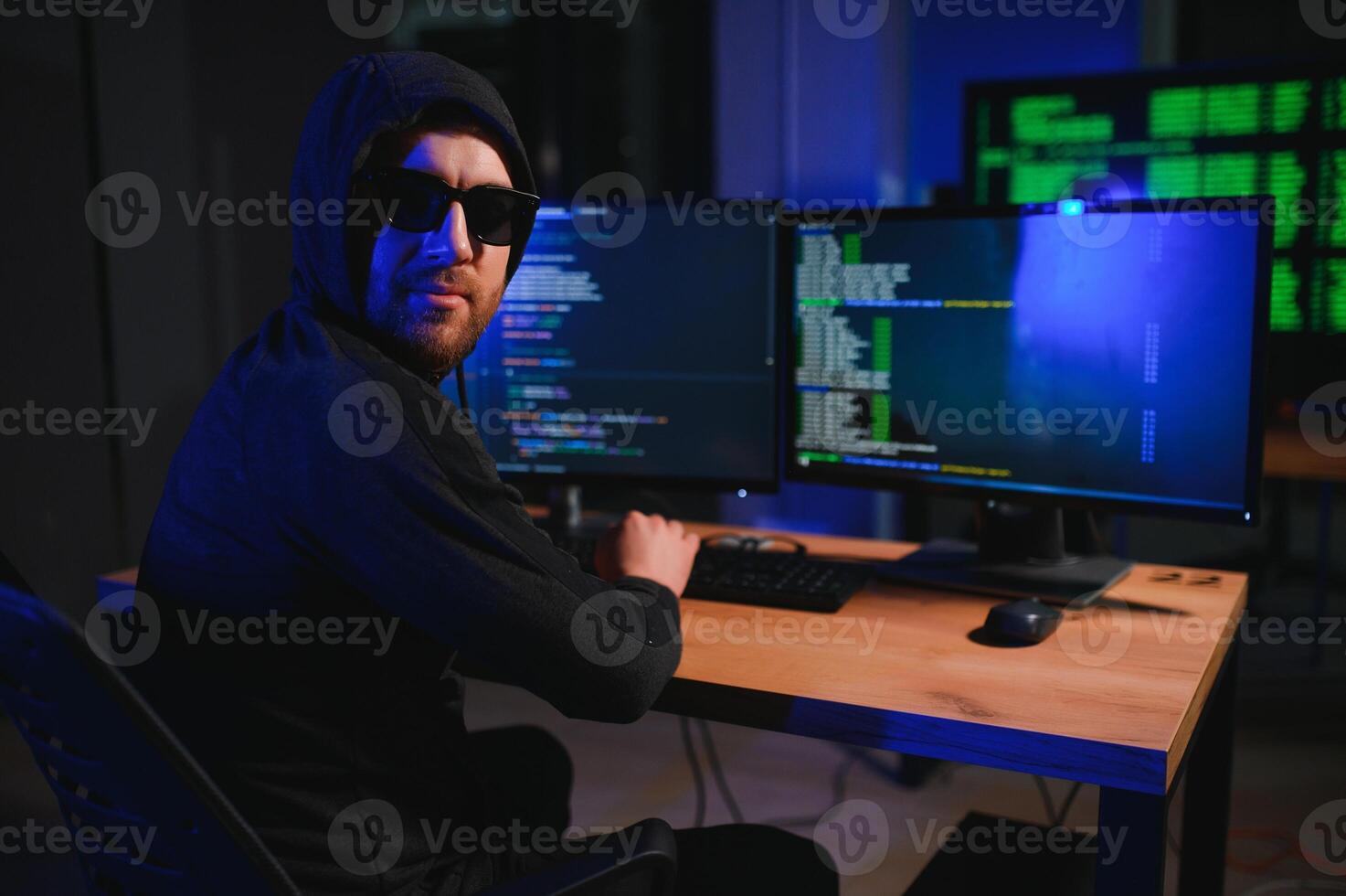 Wanted hackers coding virus ransomware using laptops and computers. Cyber attack, system breaking and malware concept photo