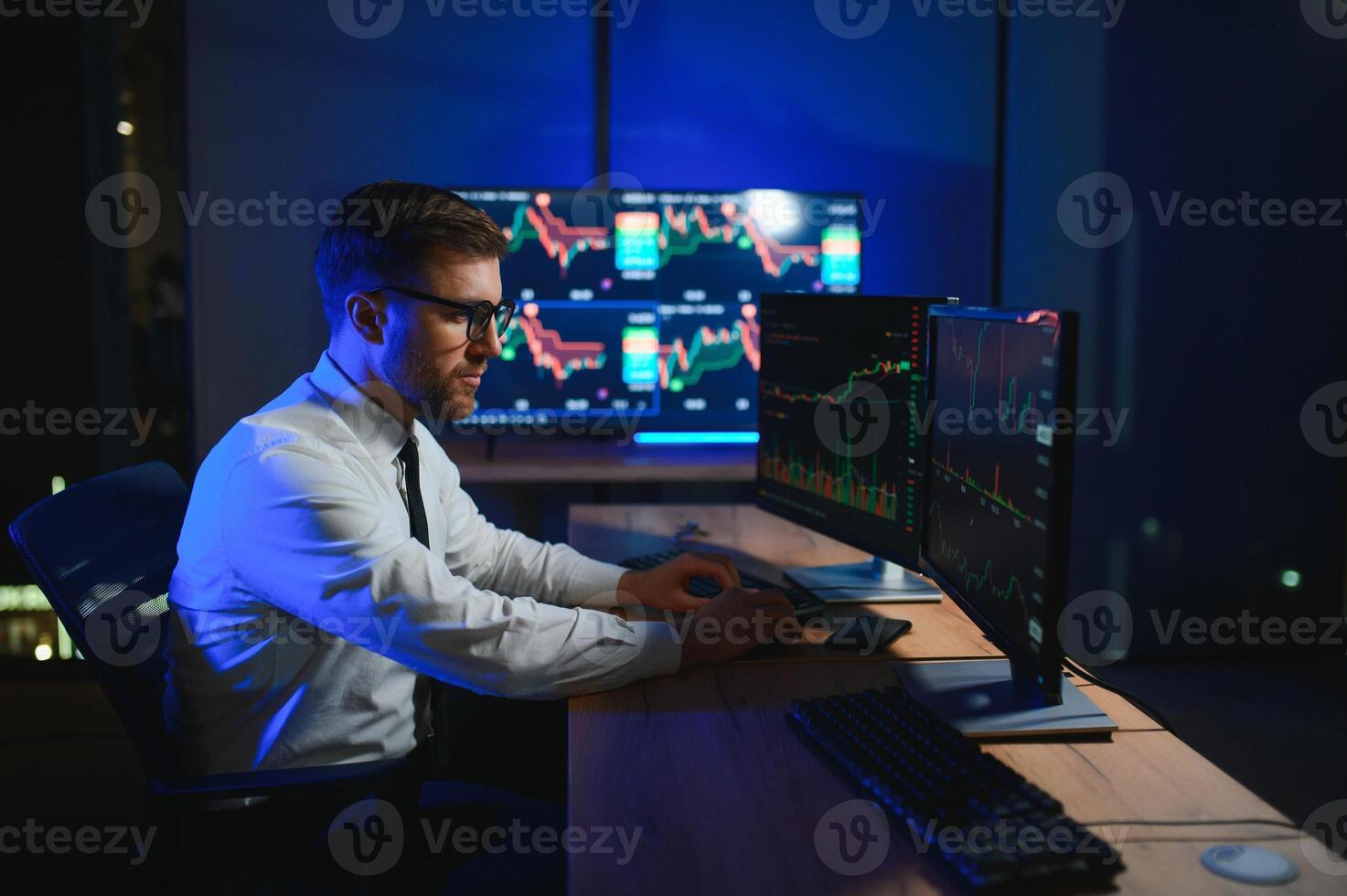 Financial Analysts and Day Traders Working on a Computers with Multi-Monitor photo