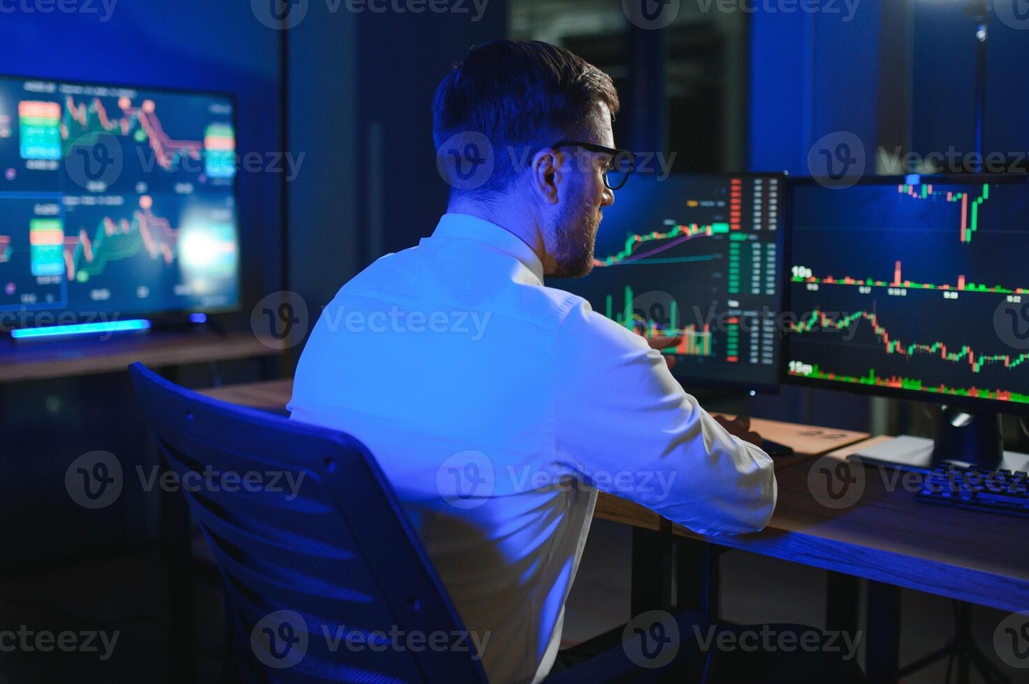 Financial Analysts and Day Traders Working on a Computers with Multi-Monitor photo