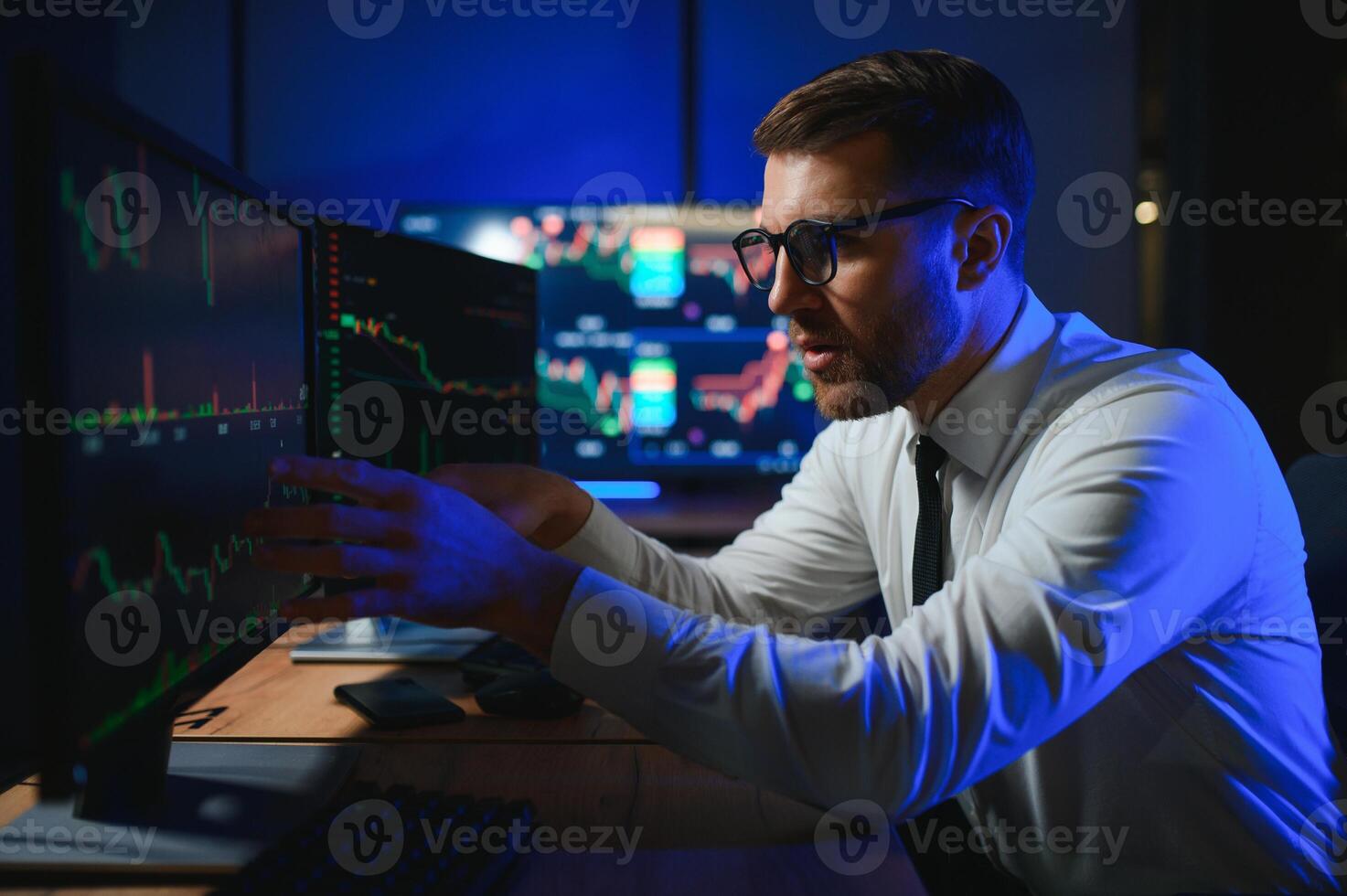 Financial Analysts and Day Traders Working on a Computers with Multi-Monitor photo