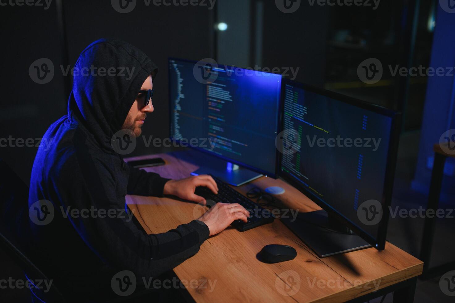 Wanted hackers coding virus ransomware using laptops and computers. Cyber attack, system breaking and malware concept photo
