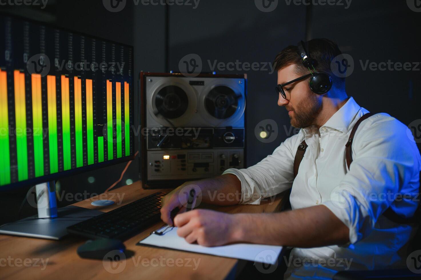 Secret agent listens on the reel tape recorder. Officer wiretapping in headphones. Spying of conversations. Intelligence gathering. Espionage concept photo