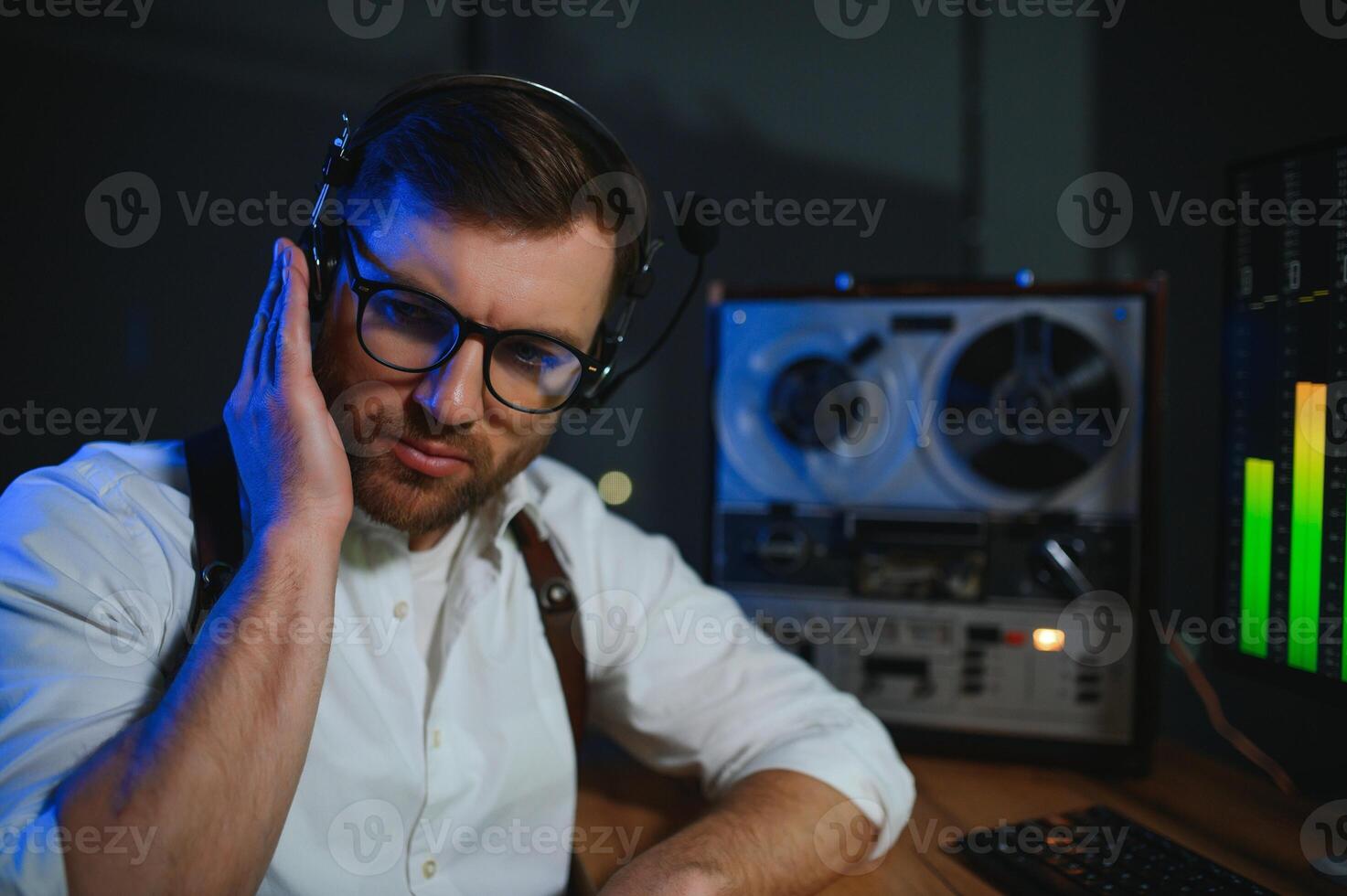 Secret agent listens on the reel tape recorder. Officer wiretapping in headphones photo