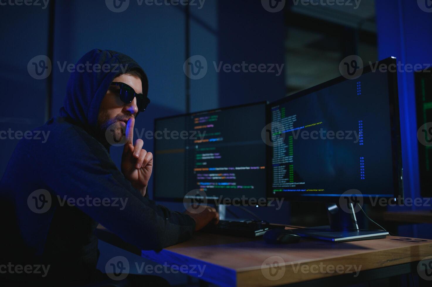 Programmer or computer hacker typing code photo