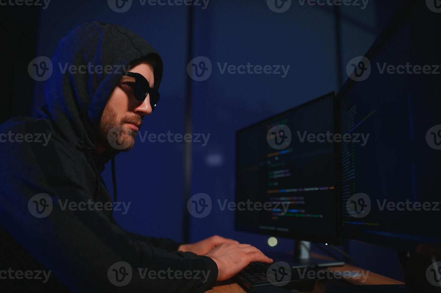 Hacker is hacking into the computer network. Computer criminal photo