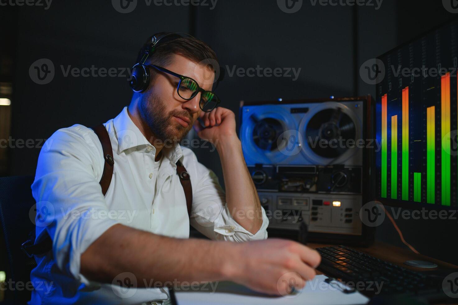 Secret agent listens on the reel tape recorder. Officer wiretapping in headphones. Spying of conversations. Intelligence gathering. Espionage concept photo