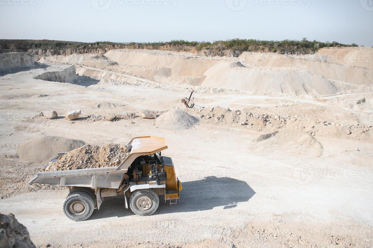 Large quarry dump truck. Big yellow mining truck at work site. quarry photo