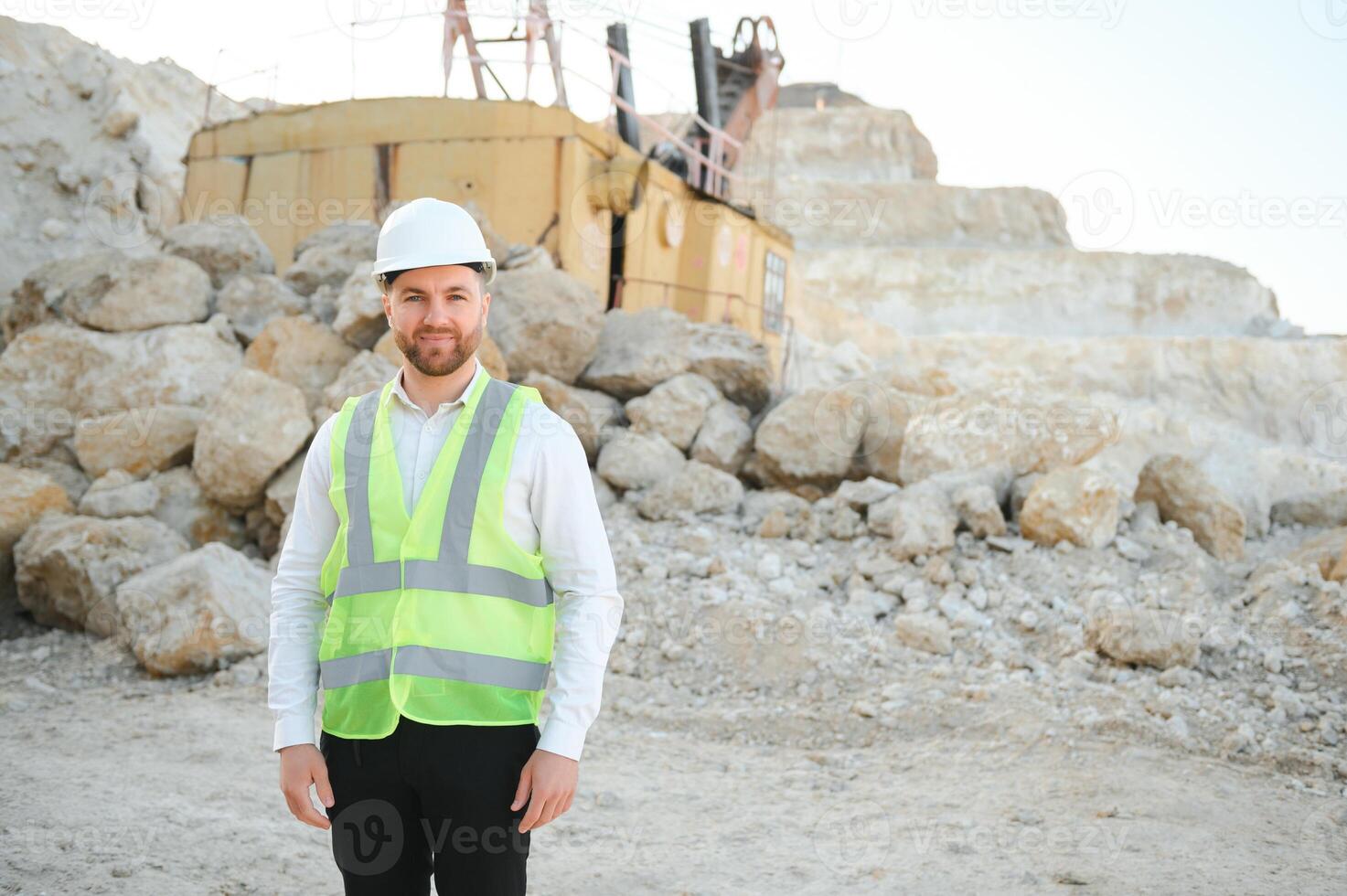 Male worker with bulldozer in sand quarry photo