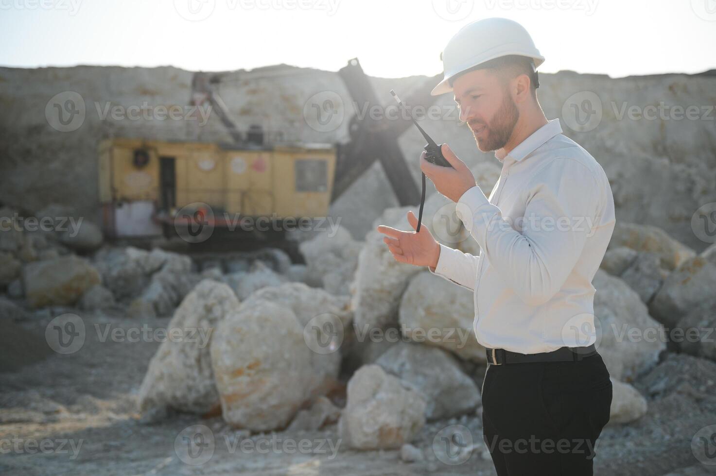 Extraction of stone. Male worker next to stone quarry. Engineer at construction site photo