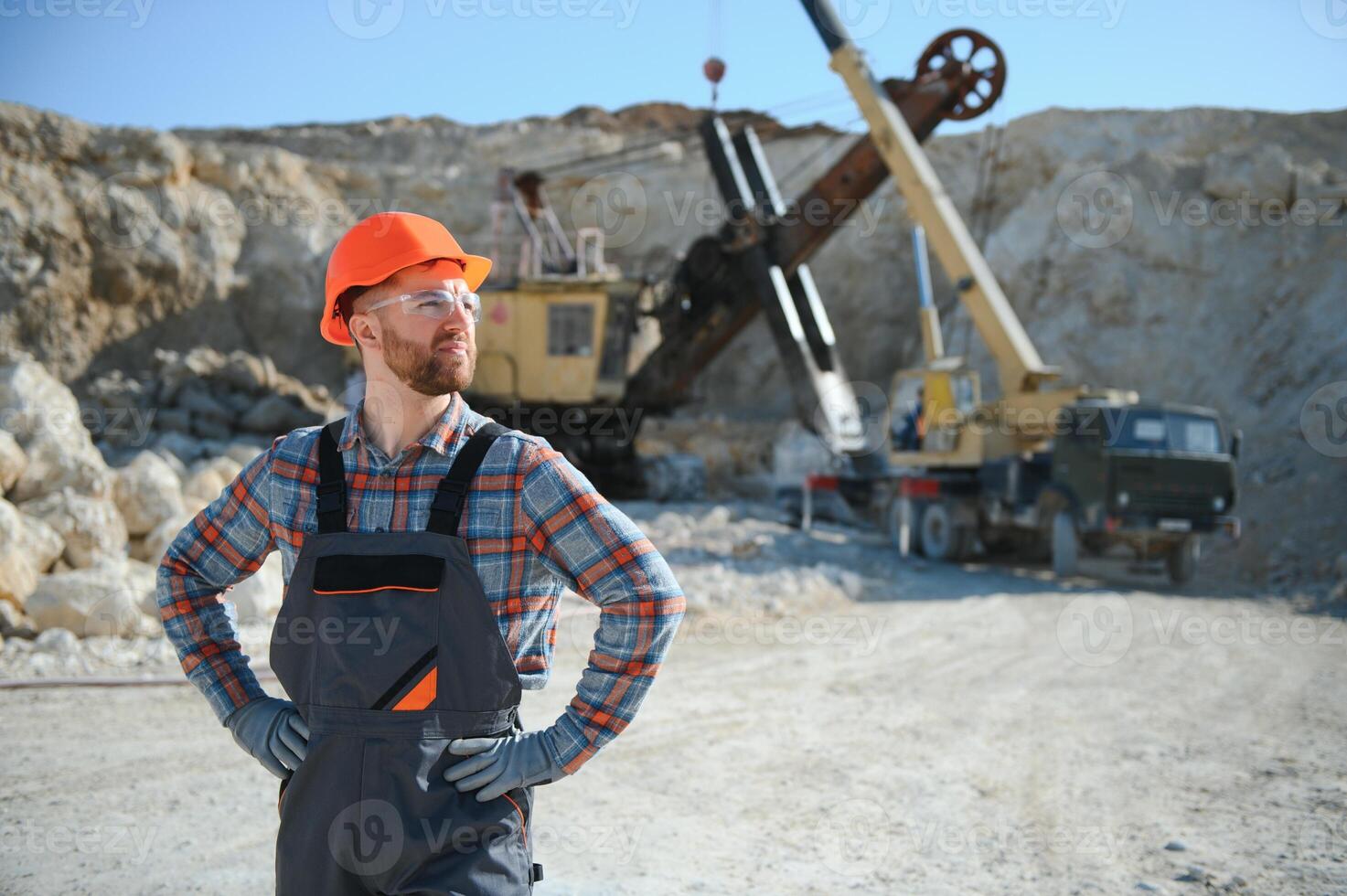 Male worker with bulldozer in sand quarry photo