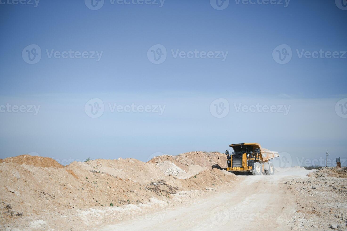 Large quarry dump truck. Big yellow mining truck at work site. quarry photo
