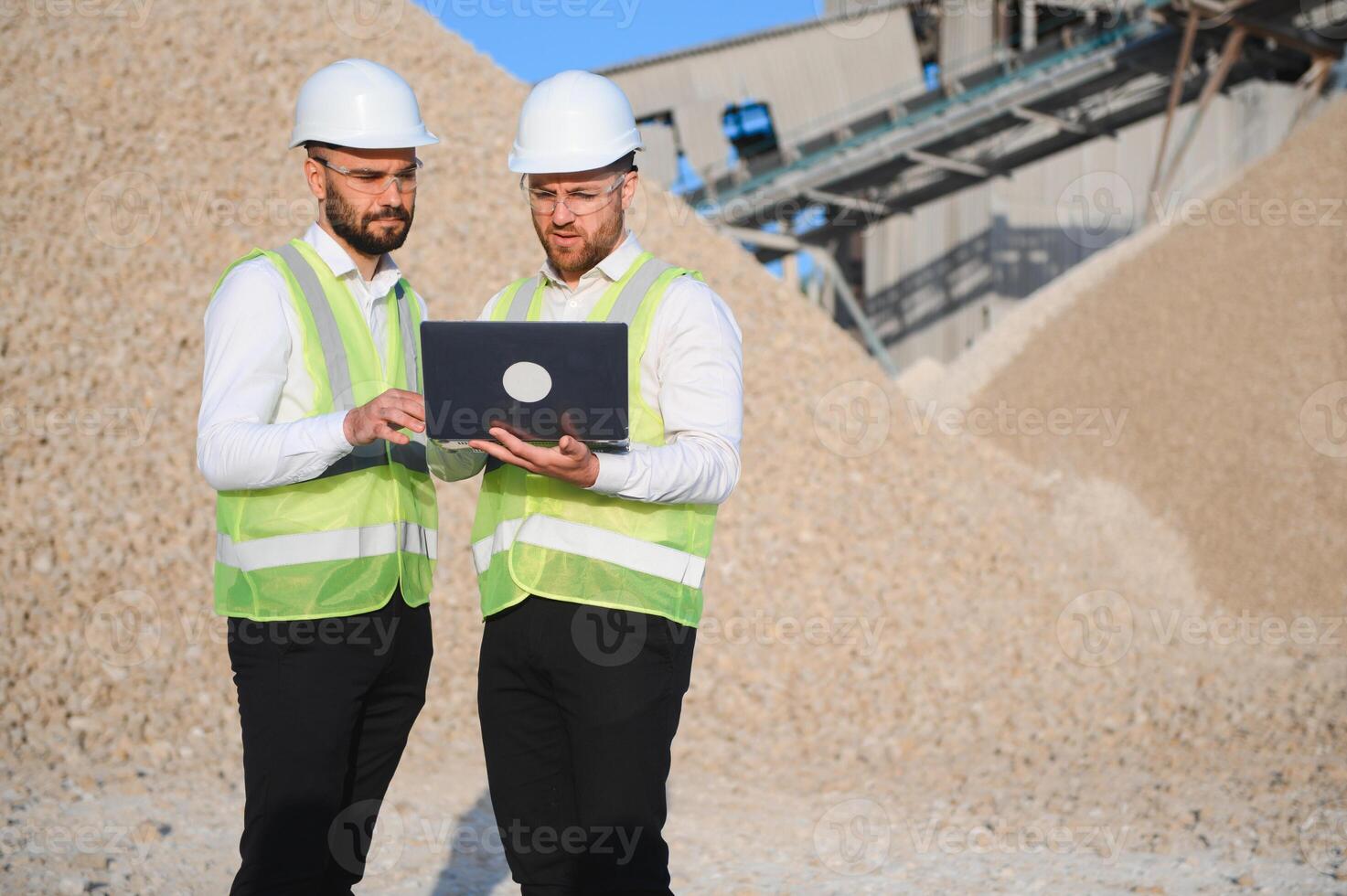 Two engineers at a stone crushing plant. The concept of quarrying. photo