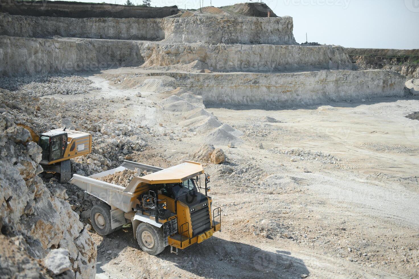 Workers talking in rock quarry photo