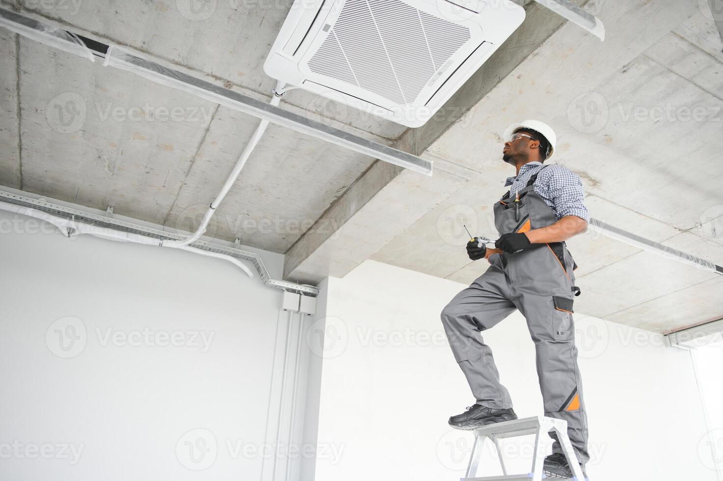AC Electrician Technician Repairing Air Conditioner Appliance photo