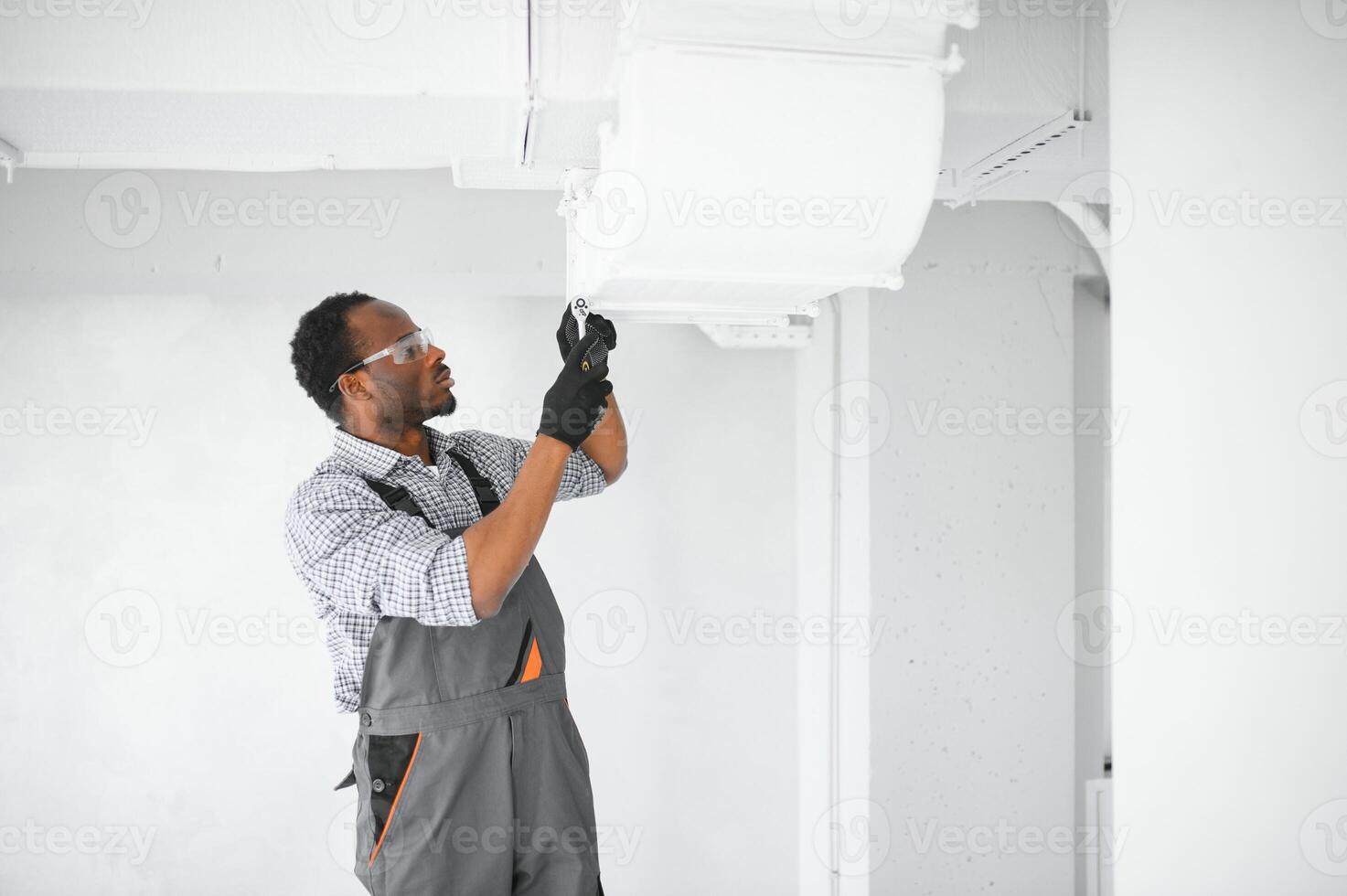 hvac worker install ducted pipe system for ventilation and air conditioning. copy space photo