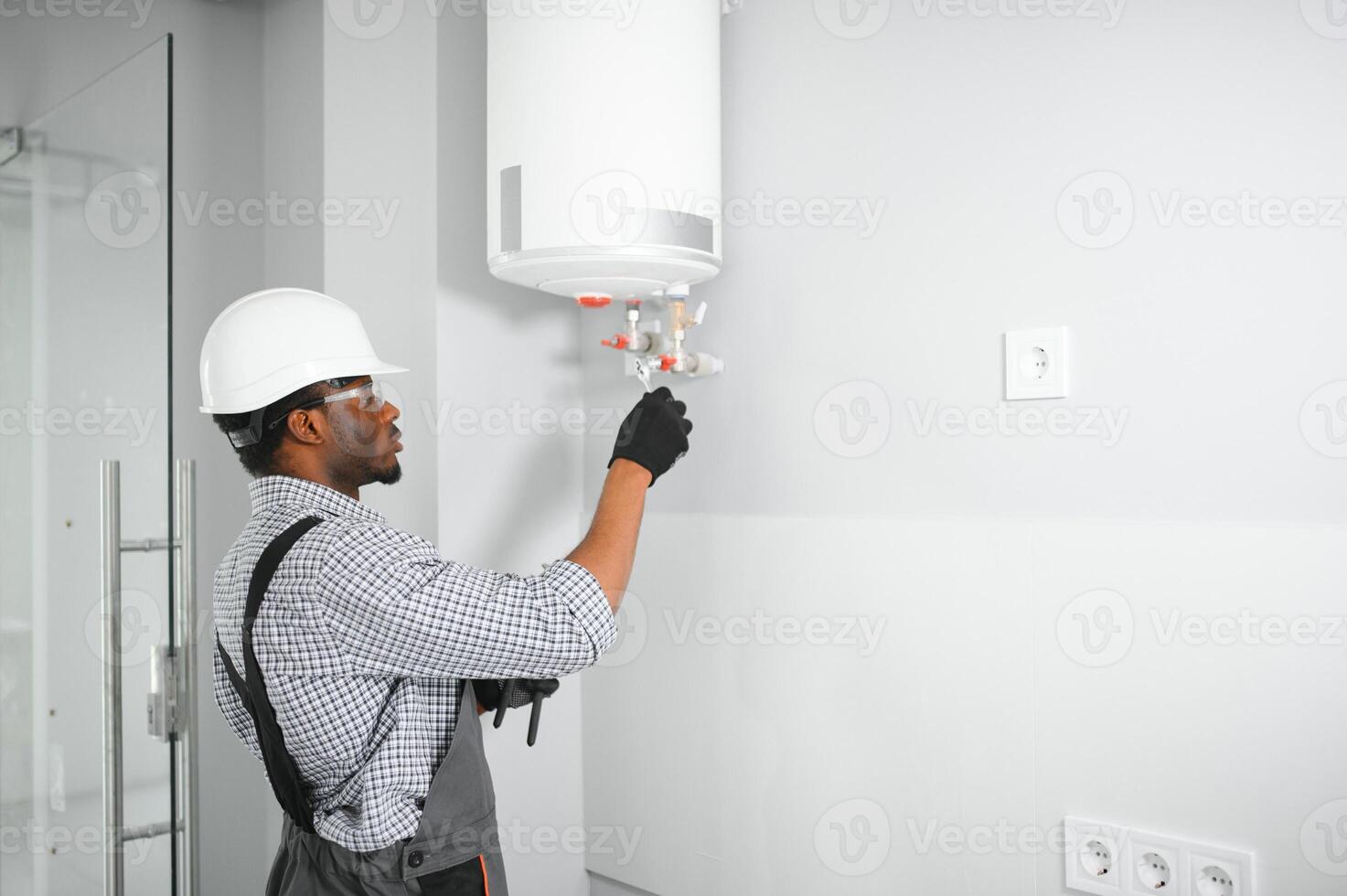 African american worker set up gas heating boiler at home photo