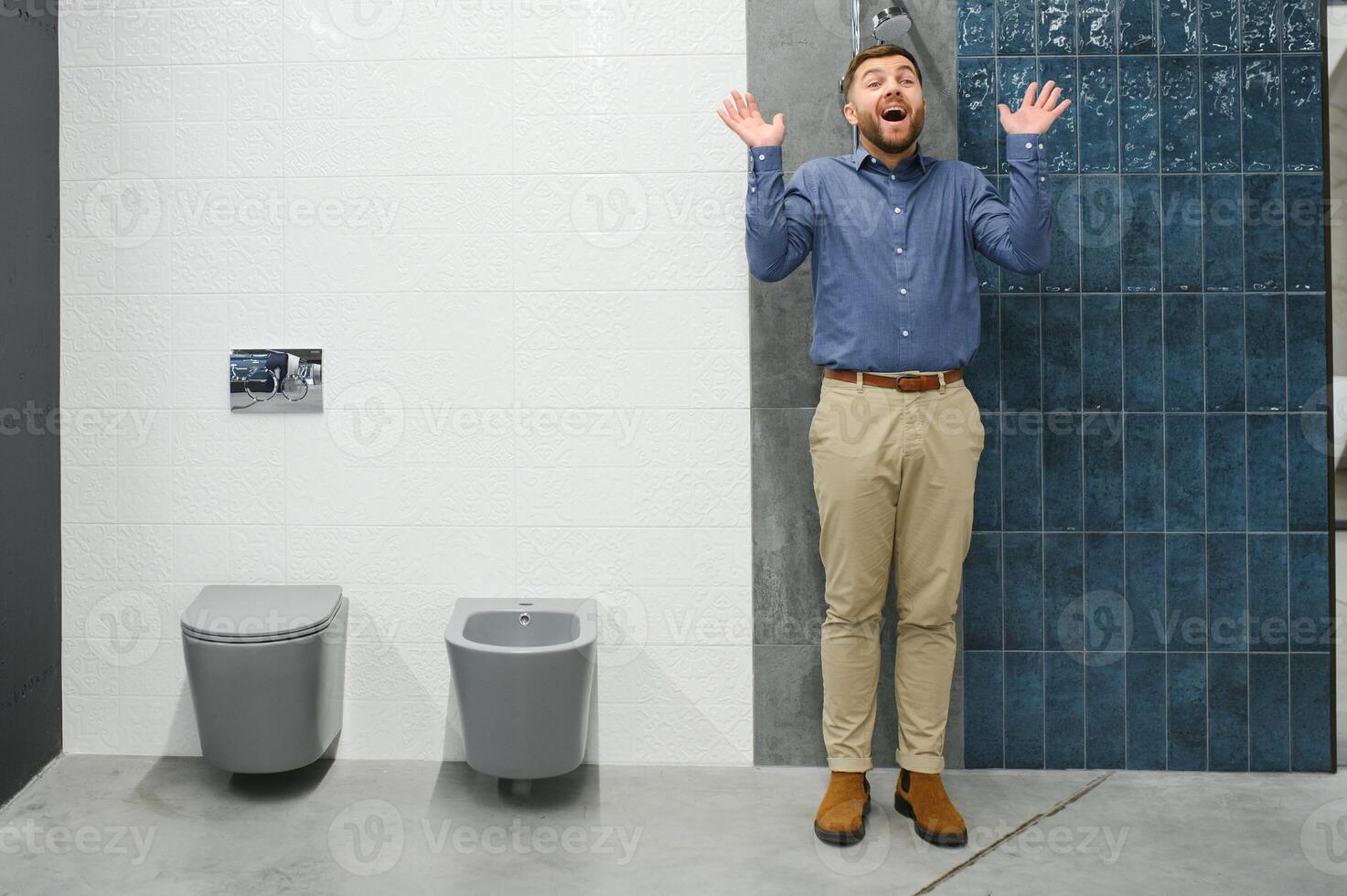 Selects a shower faucet. Man chooses a products in a sanitary ware store photo