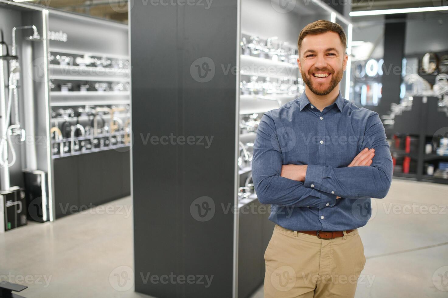 Playing with shower faucet. Man chooses a products in a sanitary ware store photo