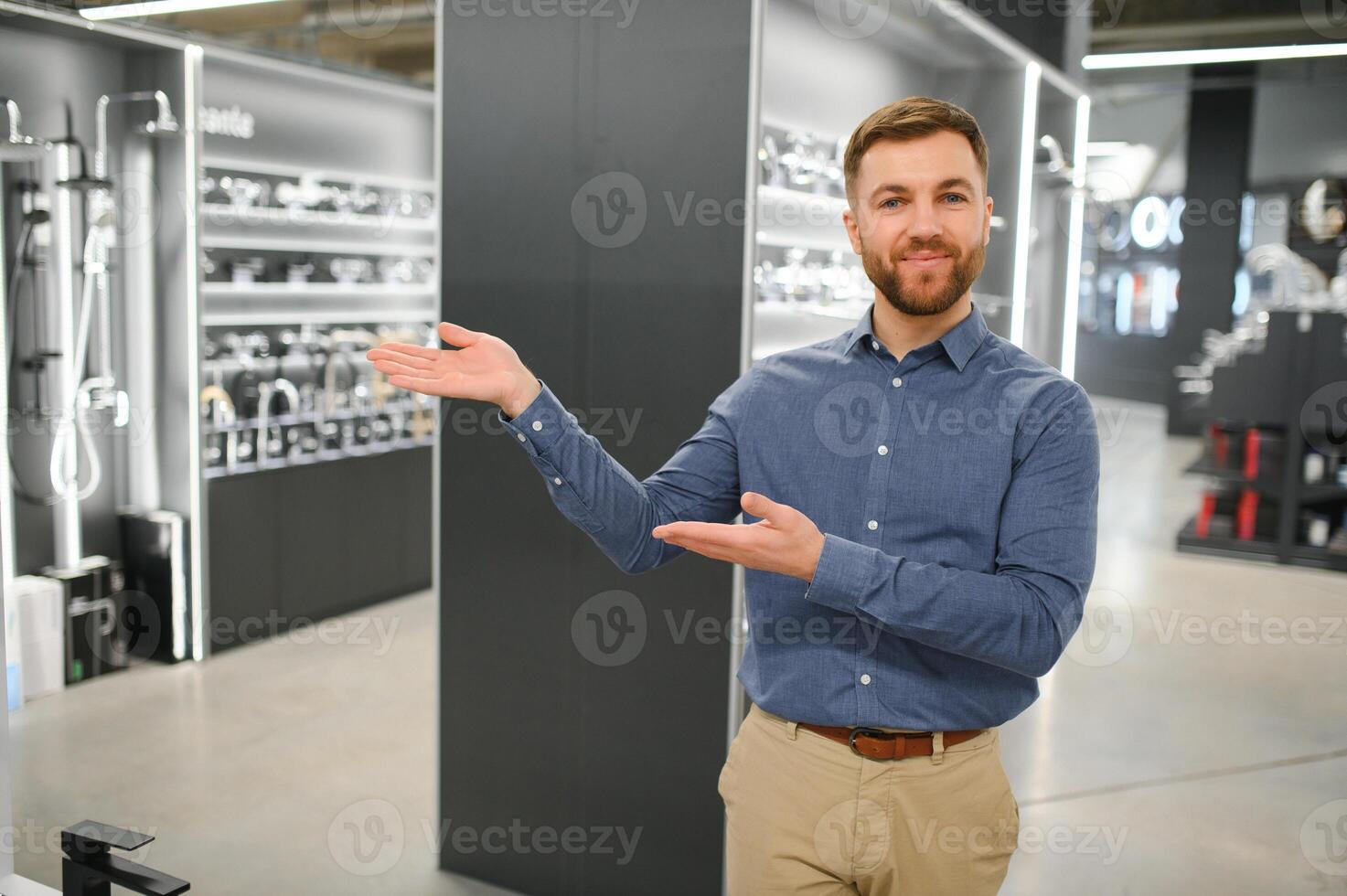 Portrait of salesperson in bathroom store. Happy man works in bath store. Sales occupation photo