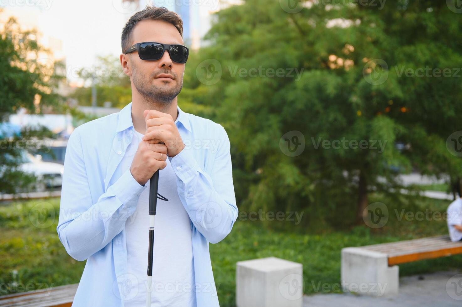 Blind man. Visually impaired man with walking stick, photo