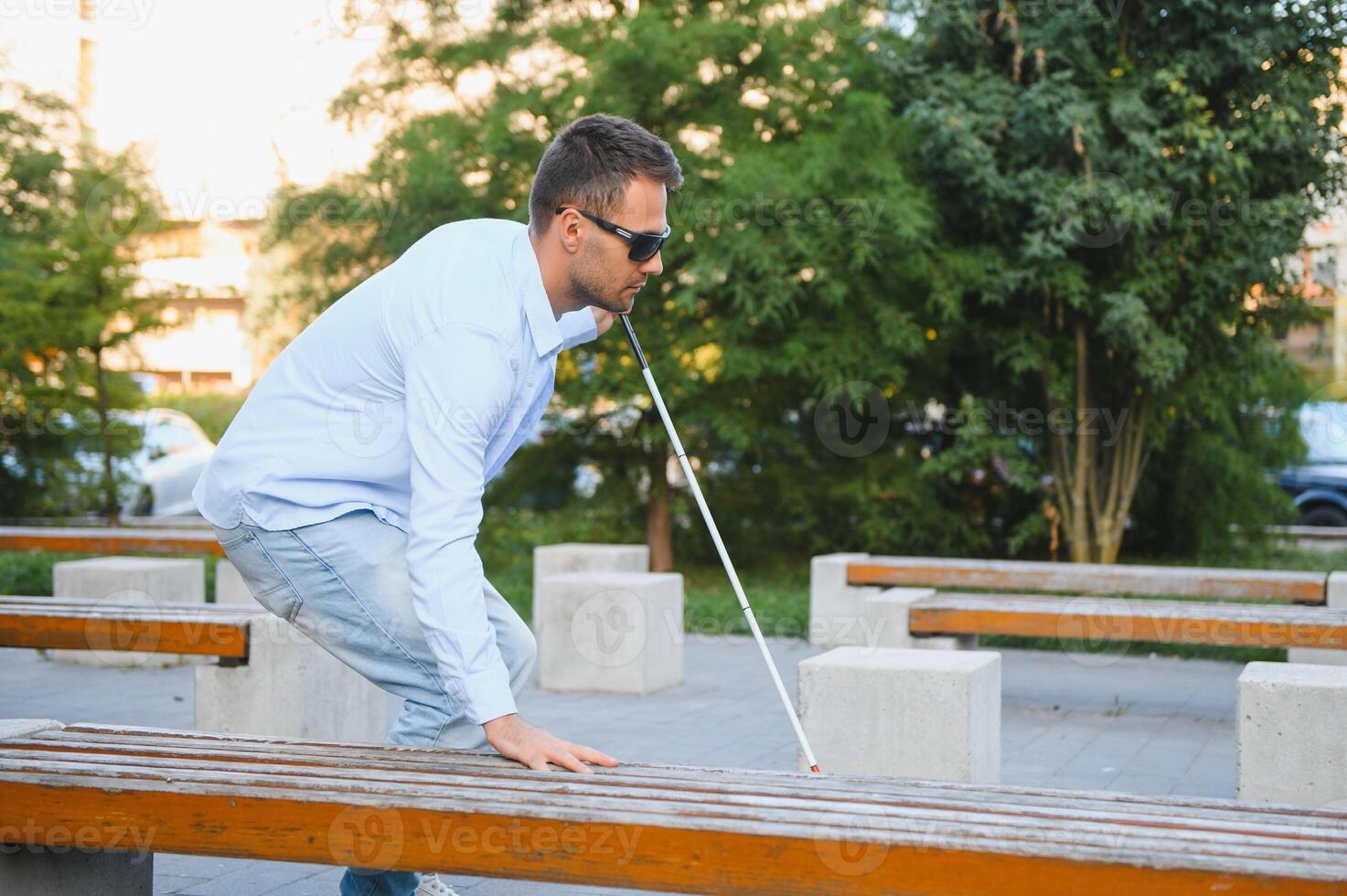 Blind man. Visually impaired man with walking stick, photo