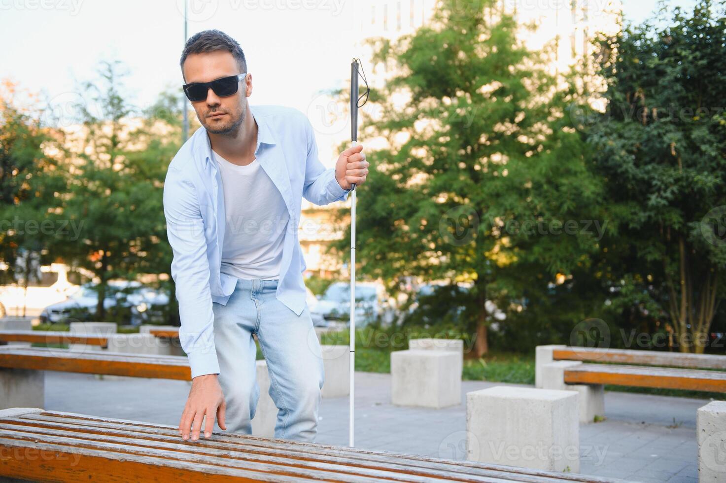 Blind man. Visually impaired man with walking stick, photo