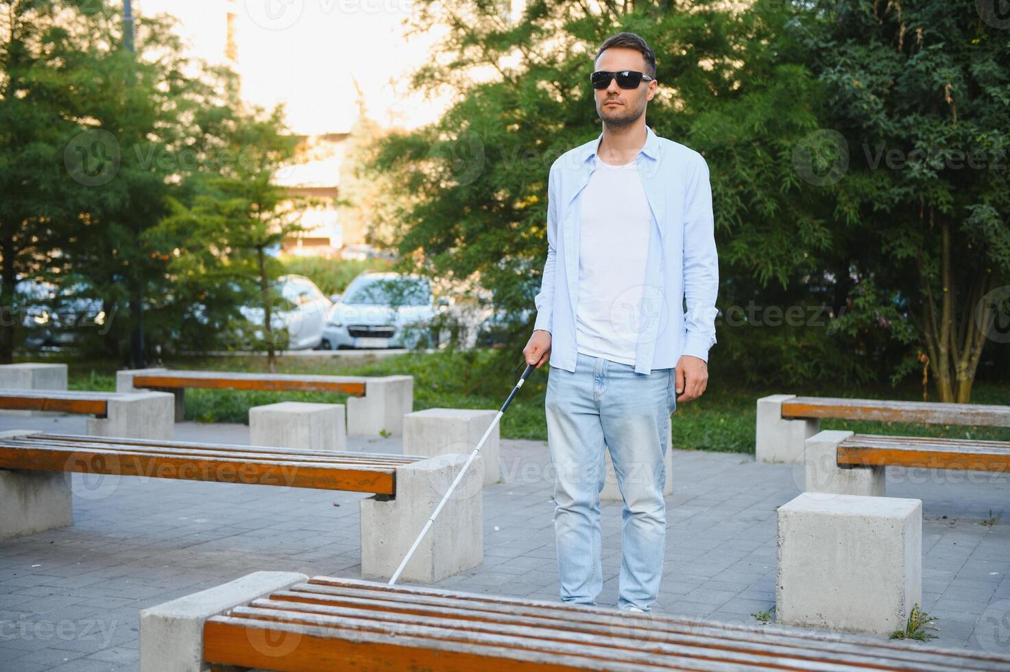 Blind man. Visually impaired man with walking stick, photo