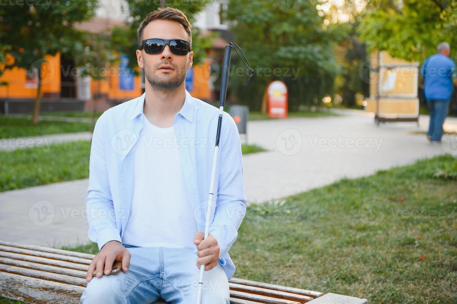 Blind man. Visually impaired man with walking stick, photo